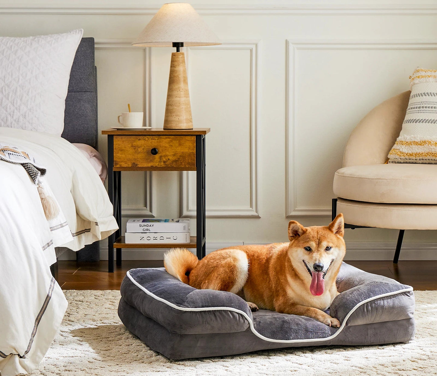 Dog lying on a gray pet bed in a cozy bedroom.